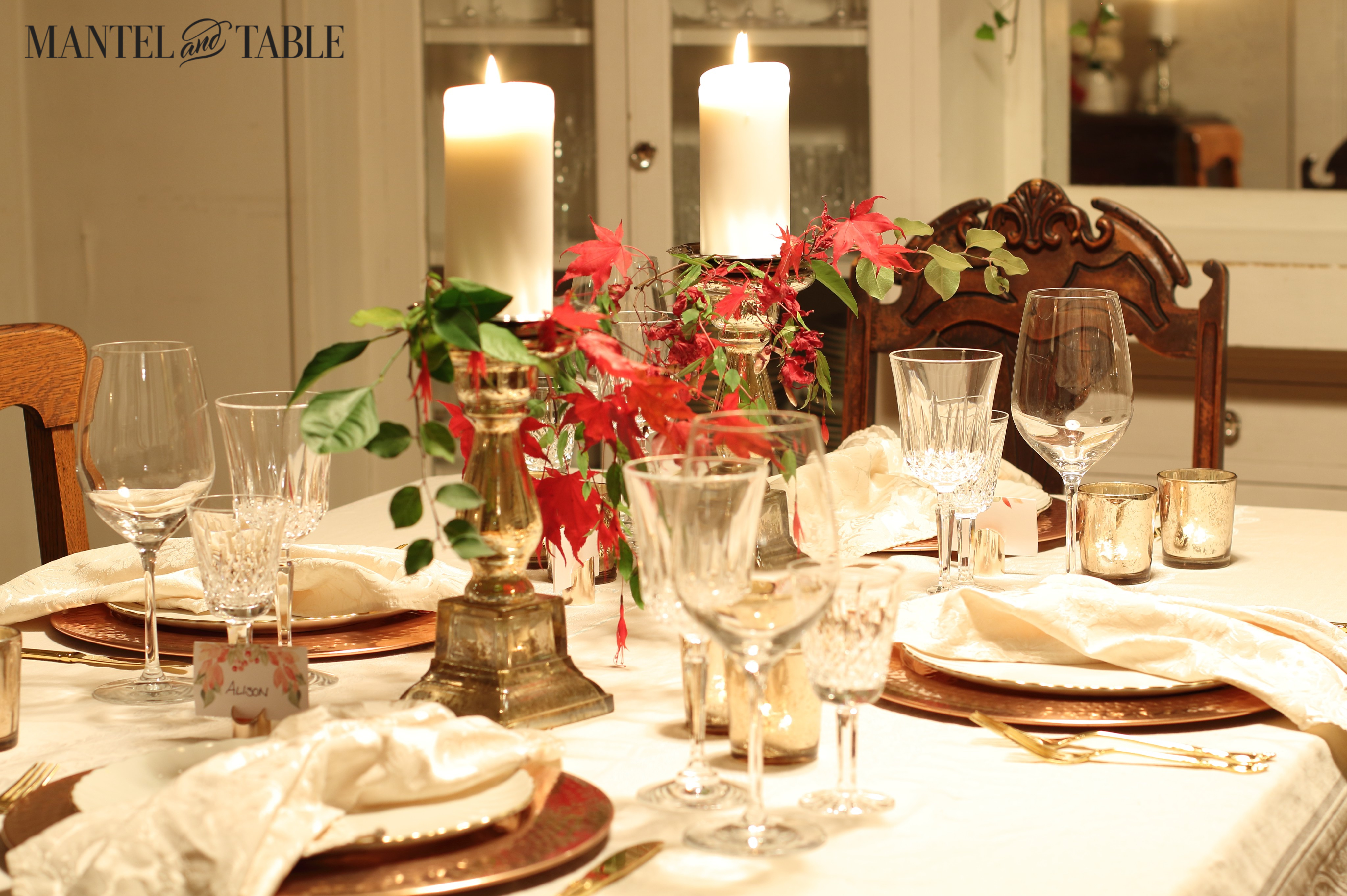Thanksgiving Table - white cloth, copper chargers,white plates, gold pillar candlesticks, red leaves & greenery