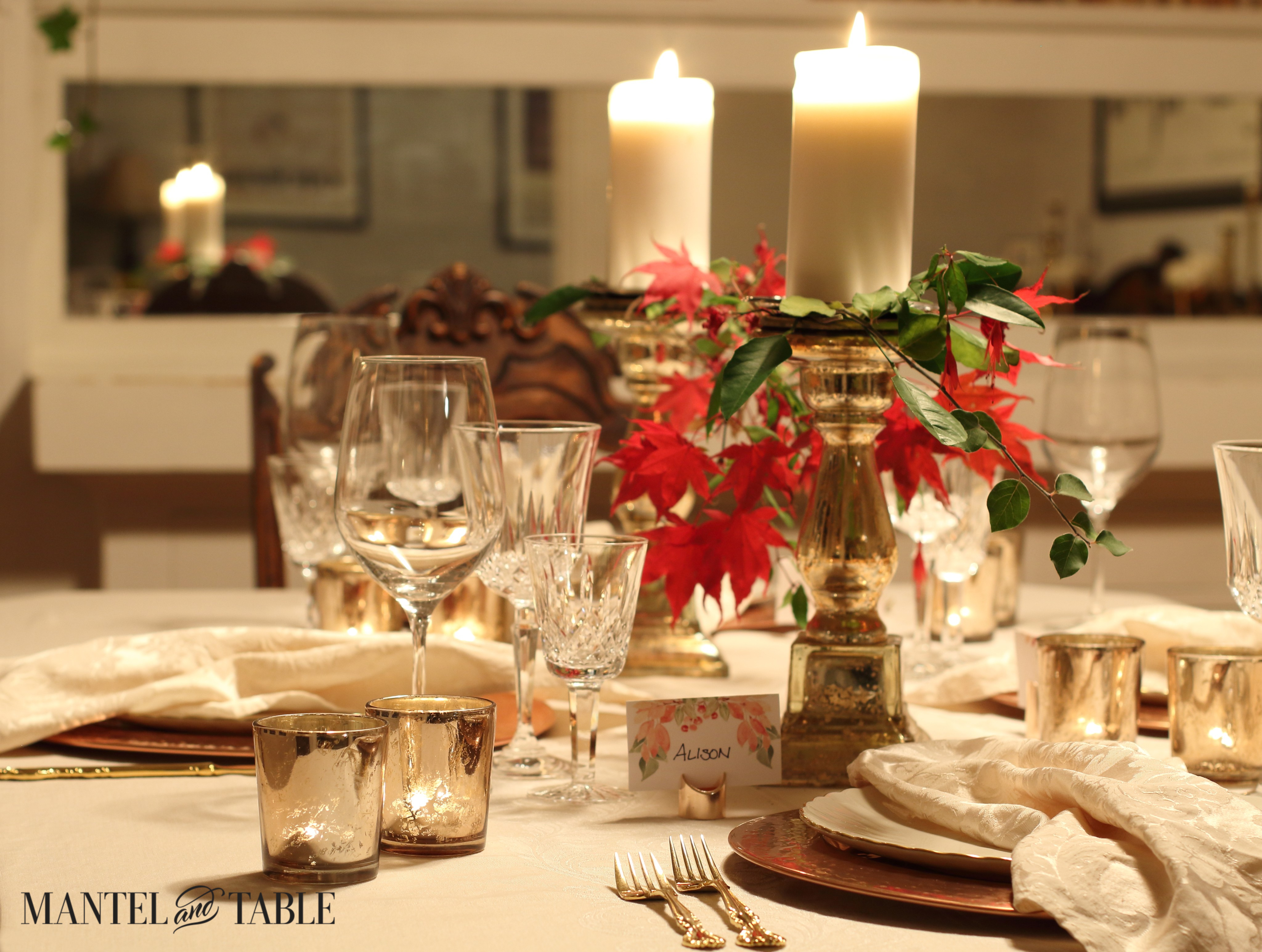Thanksgiving Table - white cloth, copper chargers,white plates, gold pillar candlesticks, red leaves & greenery