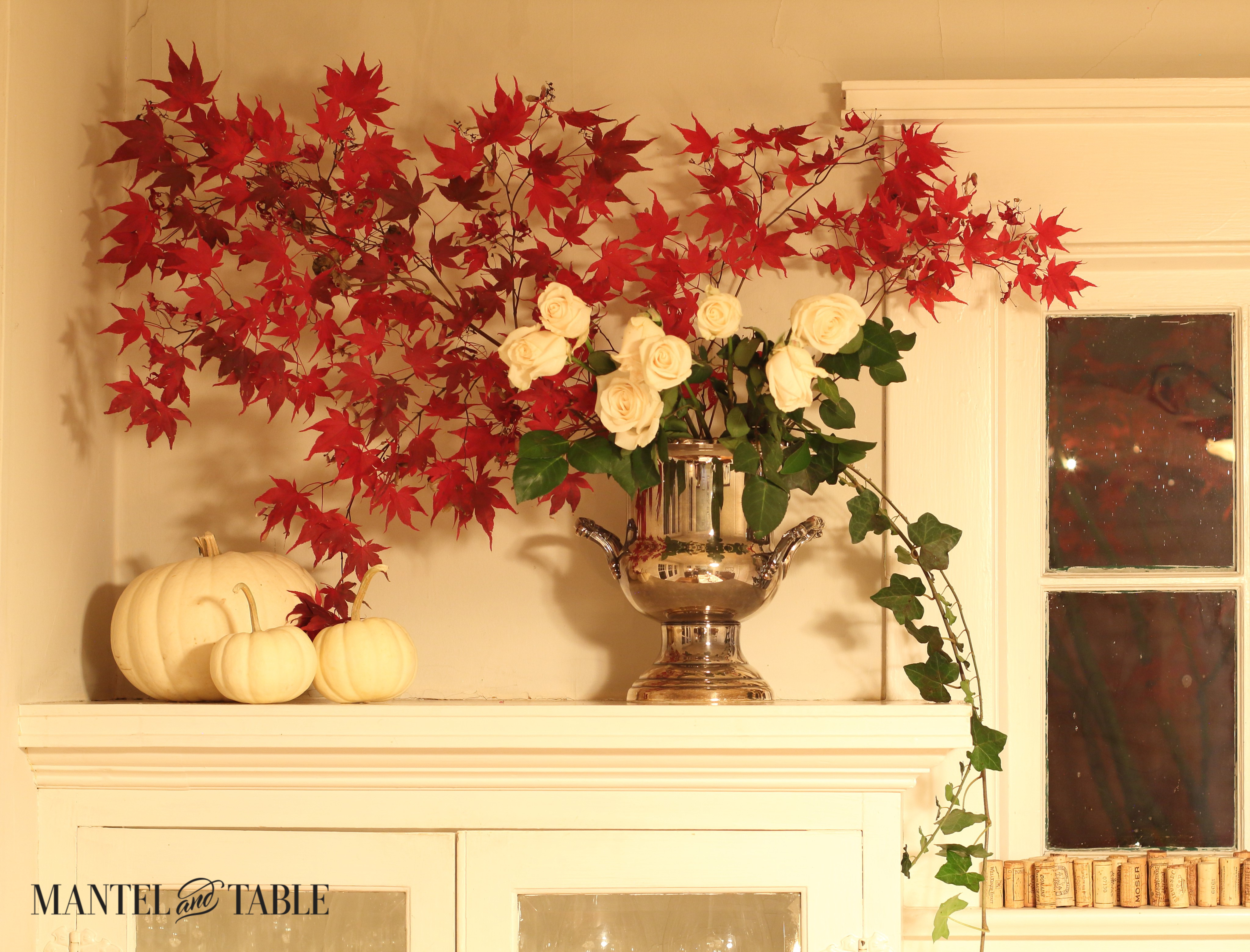 Large spray of red leaves with white roses, trailing ivy, and white pumpkins
