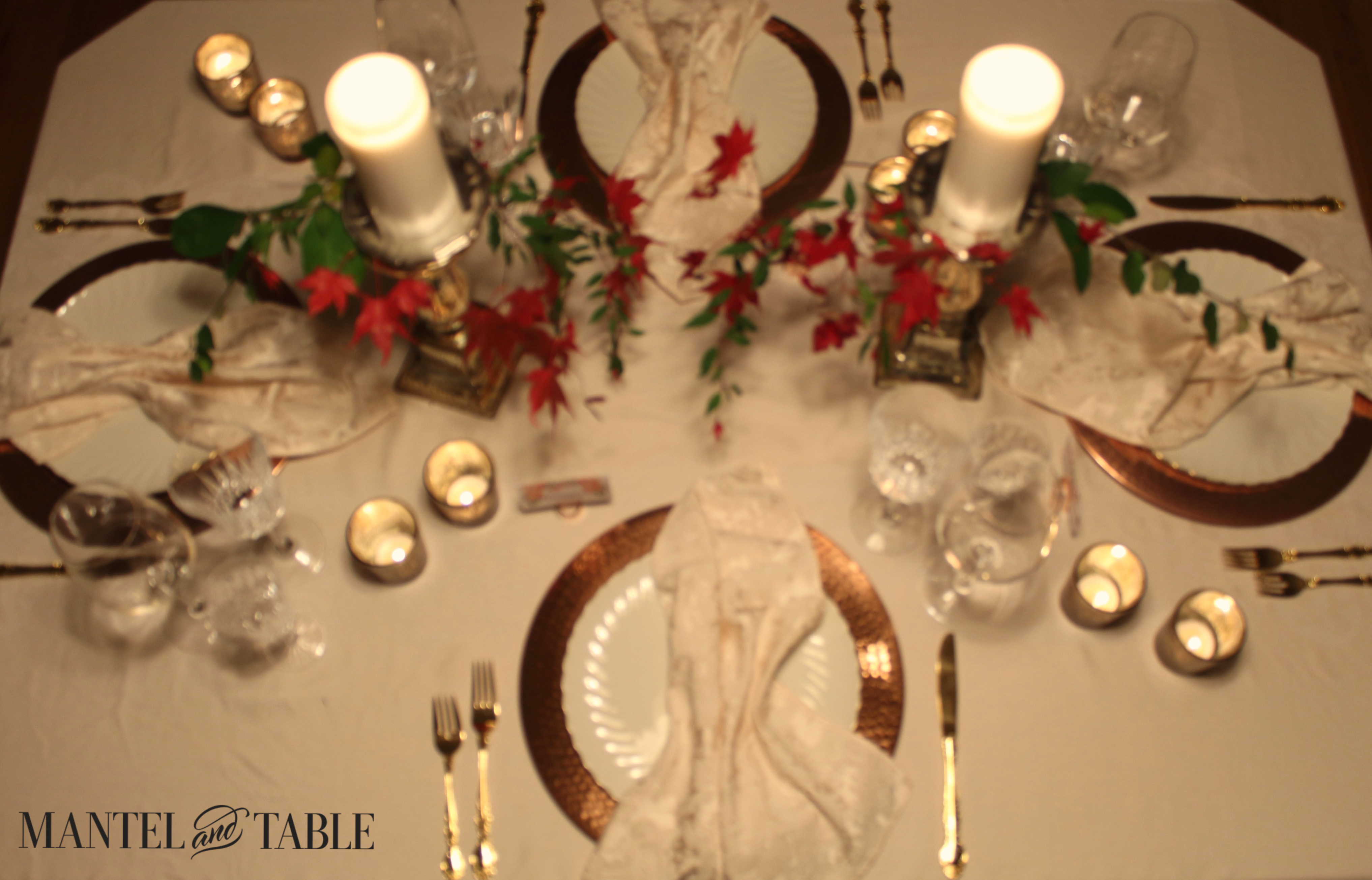 Overhead pic of Thanksgiving table with votive candles beside the settings