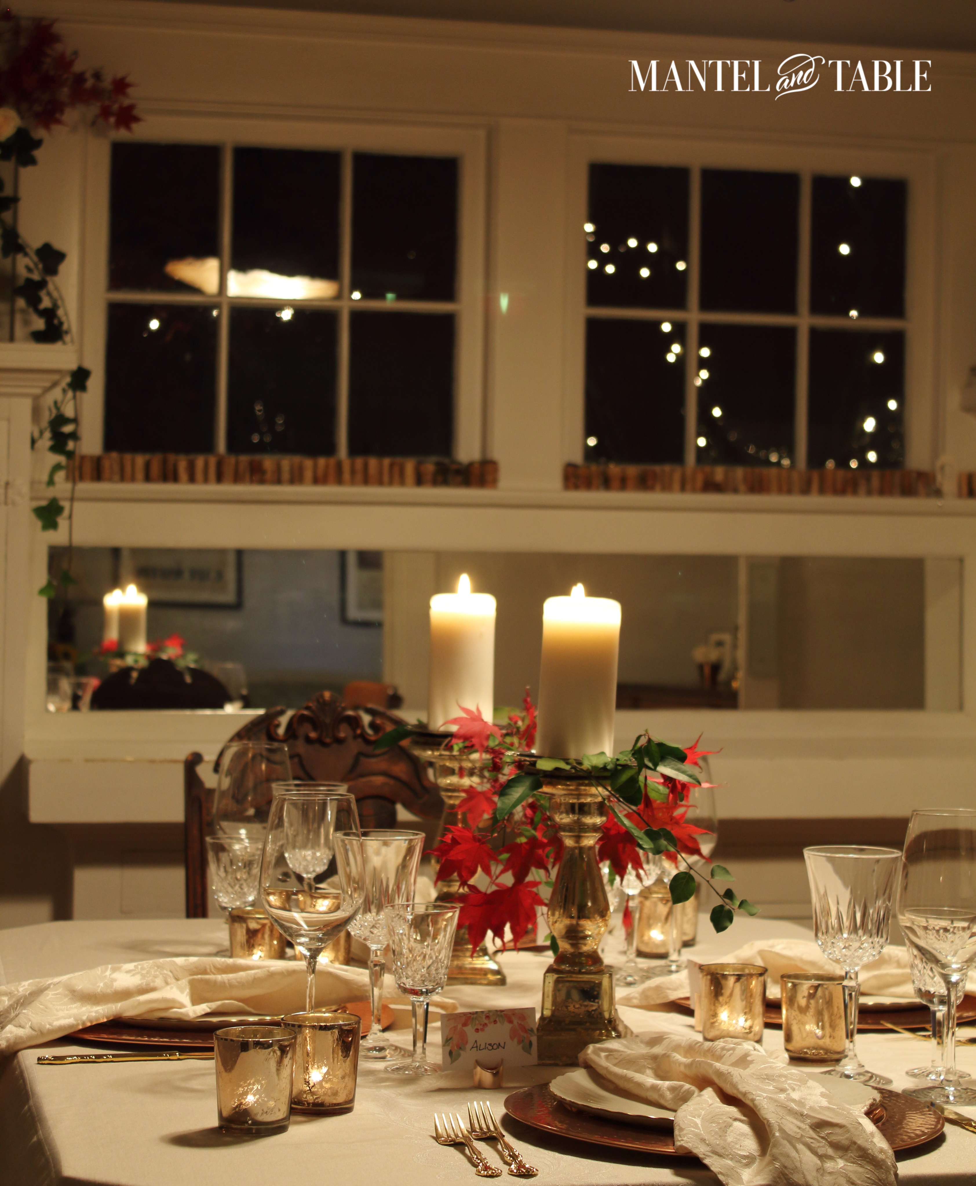 Thanksgiving table with lighted trees through the windows