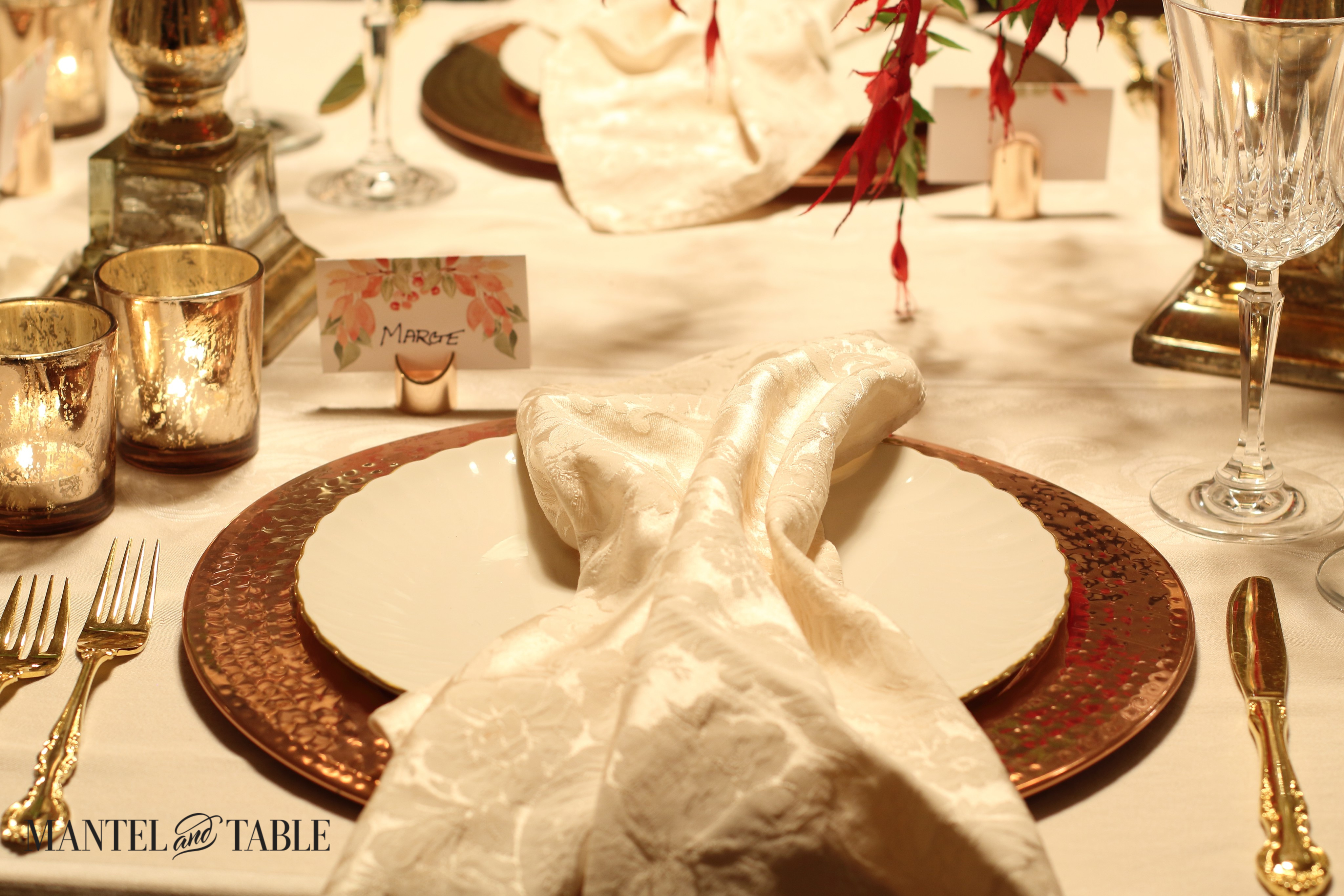 Copper charger, white scalloped plate, blush napkin. copper placecard holder on Thanksgiving table.