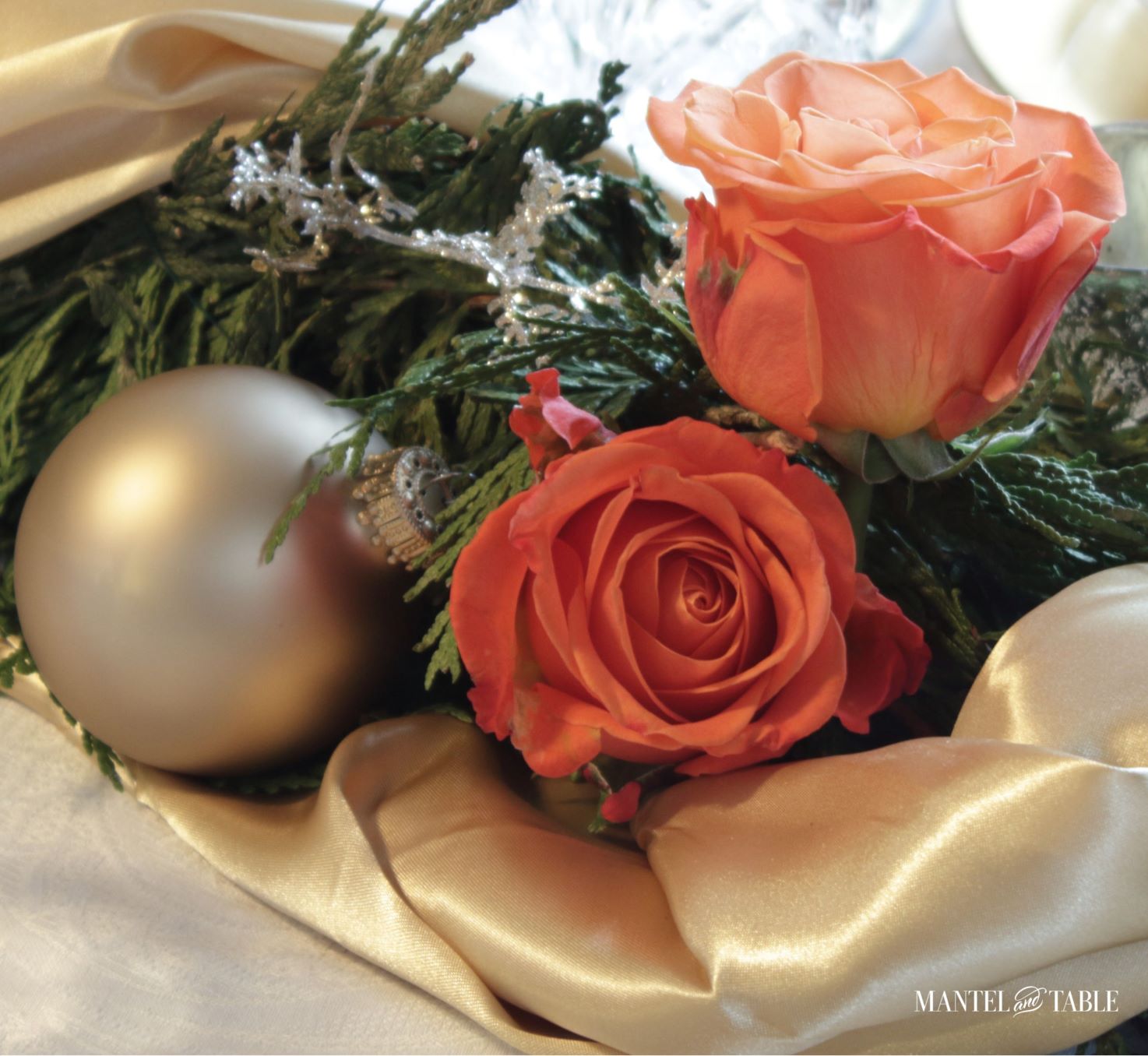 gold satin, peach roses, and evergreens in centerpiece garland