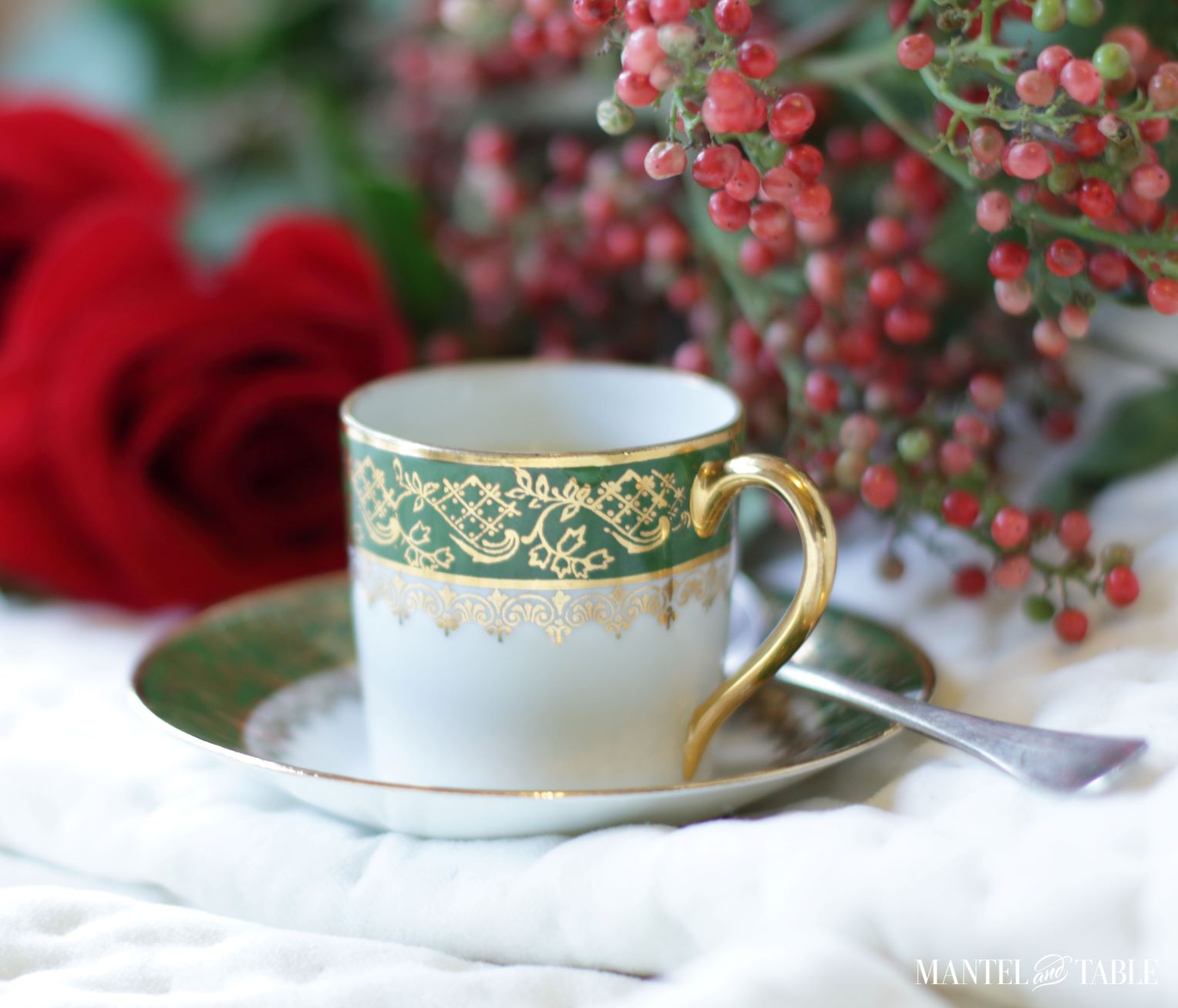 Closeup of cup sitting on saucer with silver demitasse spoon