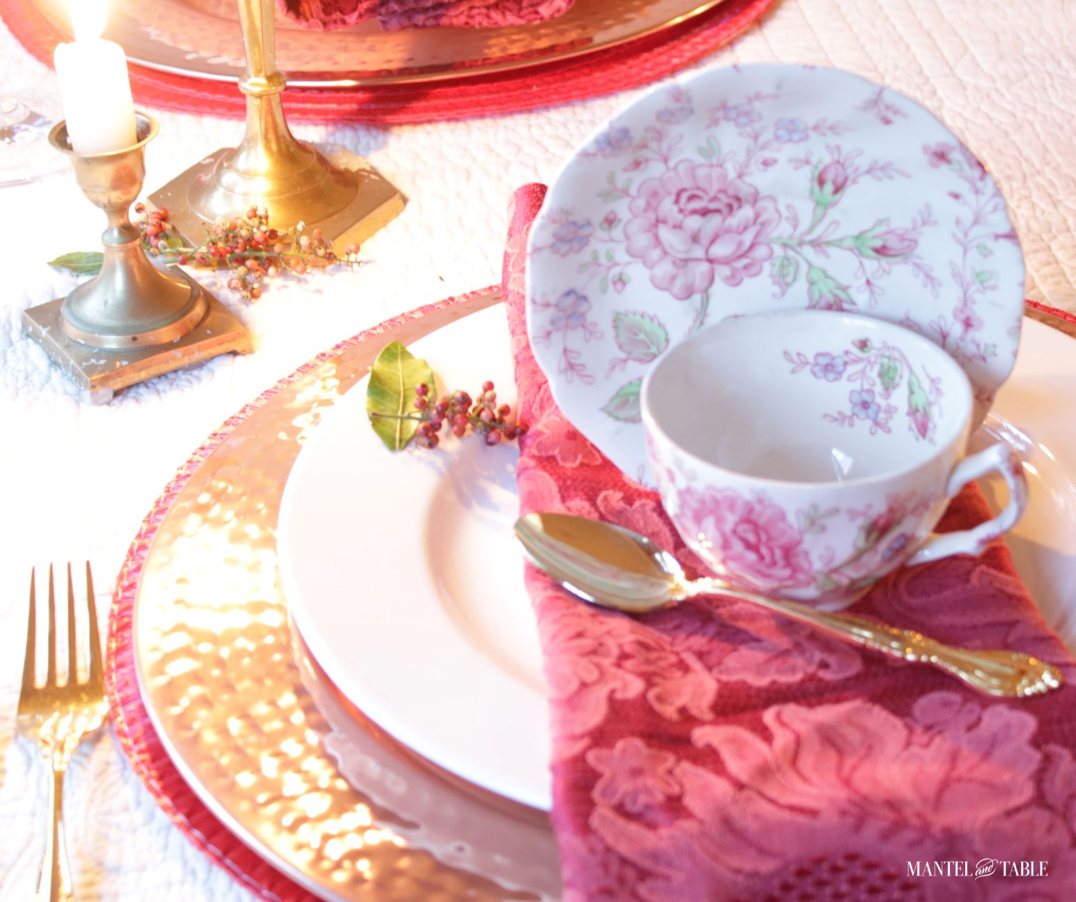 Rose Chintz teacup and saucer on place setting, brass candlesticks and tiny pink peppercorn floret