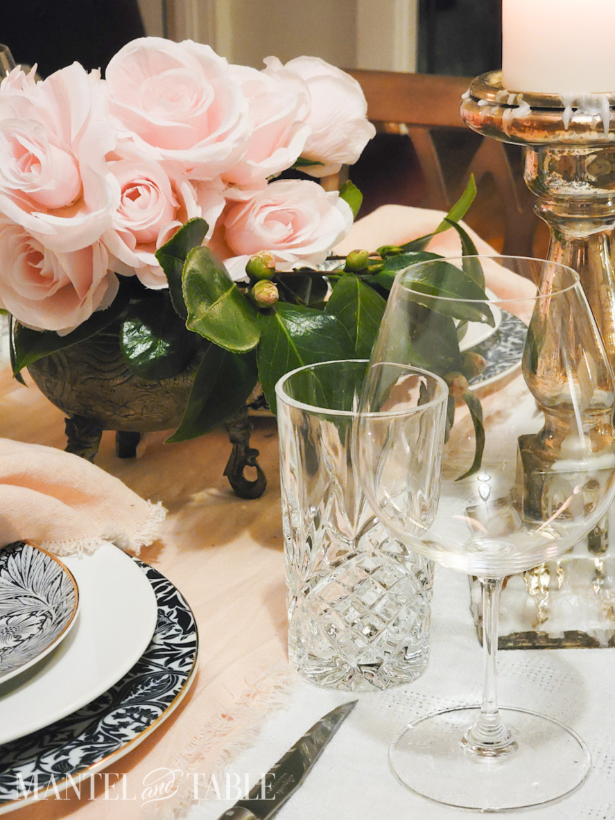 Closeup of cut crystal water glass, and round wine glass on a table