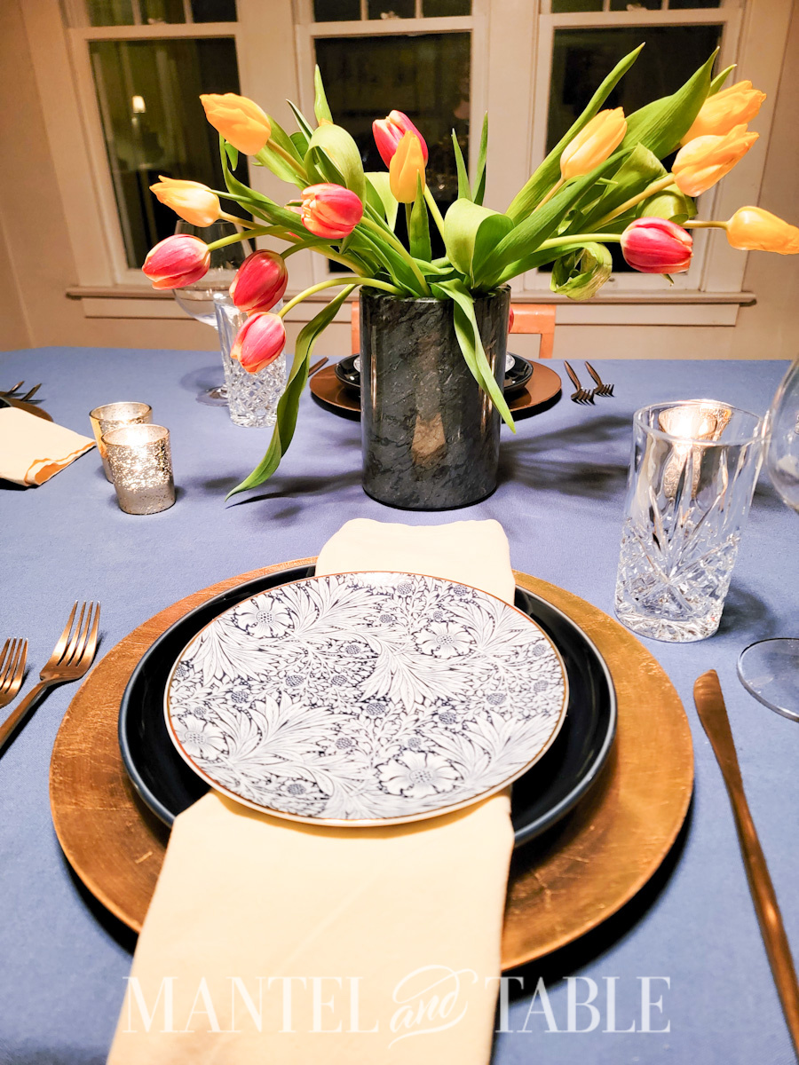 Place setting on a formal table with tulip centerpiece