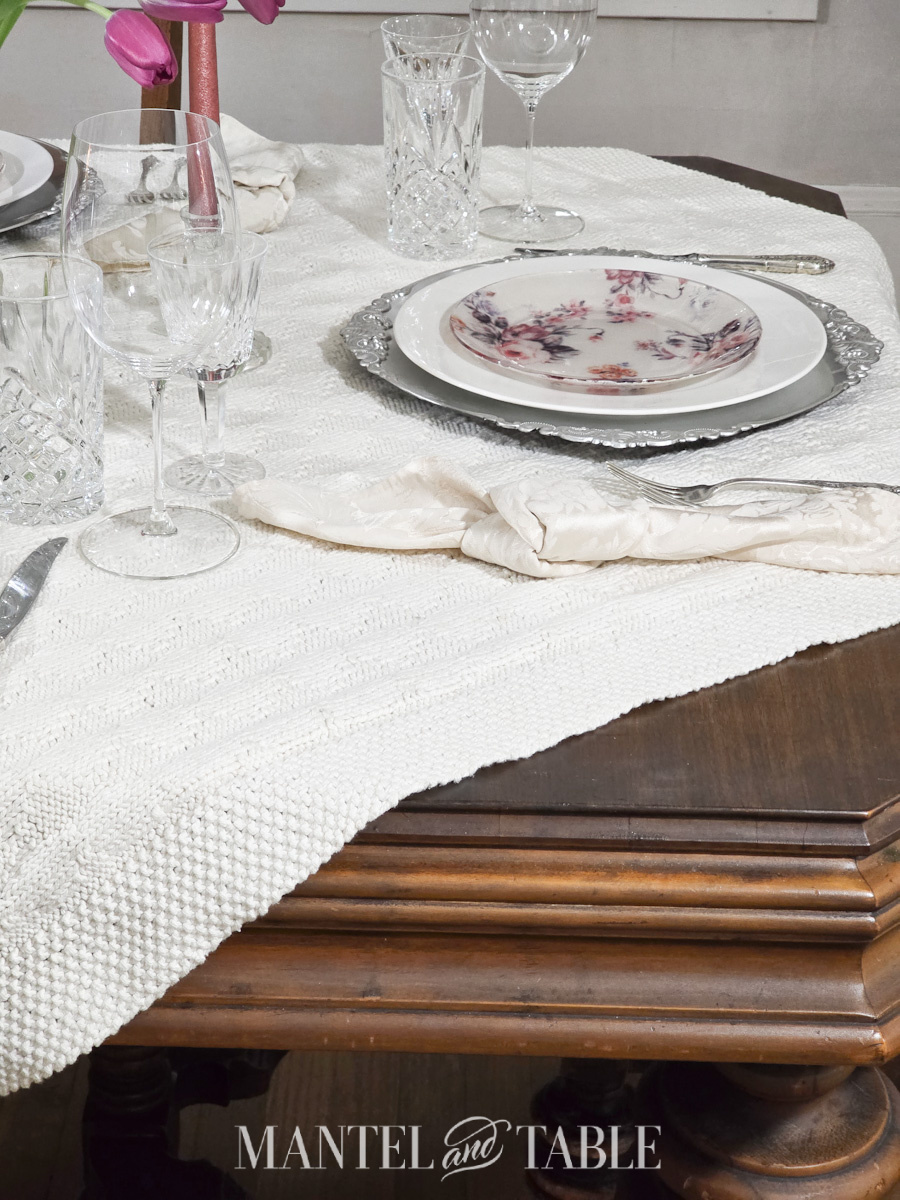 Corner of a formal table showing the tablecloth on the diagonal