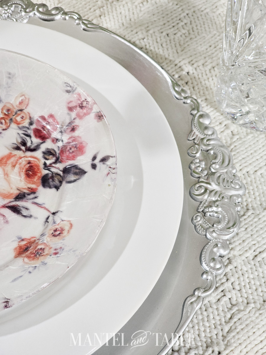 Closeup of pink floral plate on a spring dinner party table